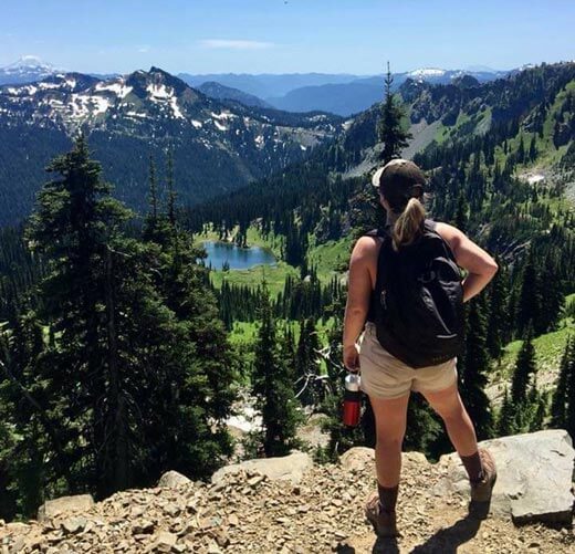hiker looking at mountain valley hiker looking at mountain valley